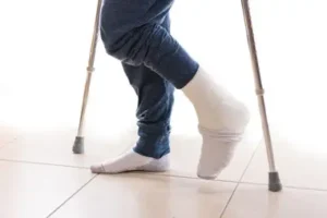 Injured man using crutches