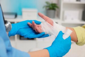 A doctor bandaging a patient who is pursuing compensation for a chemical plant injury.