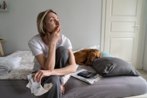 A sad woman wondering what to do if a loved one dies in an industrial work accident.